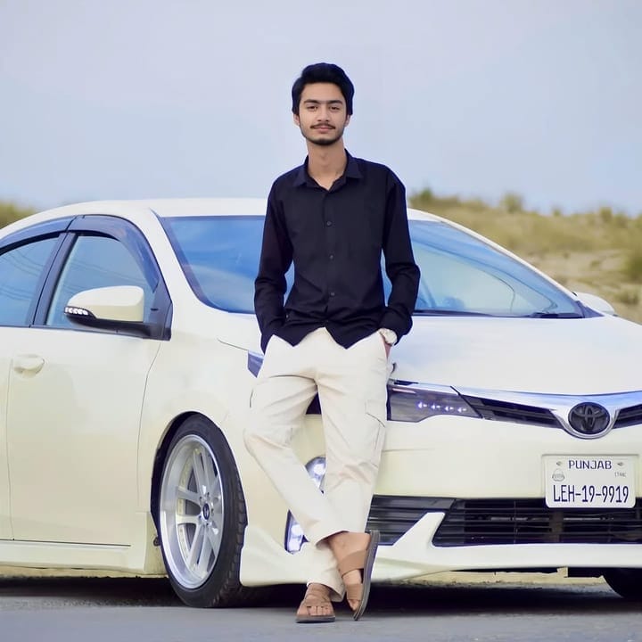 Willay Haider standing next to a car